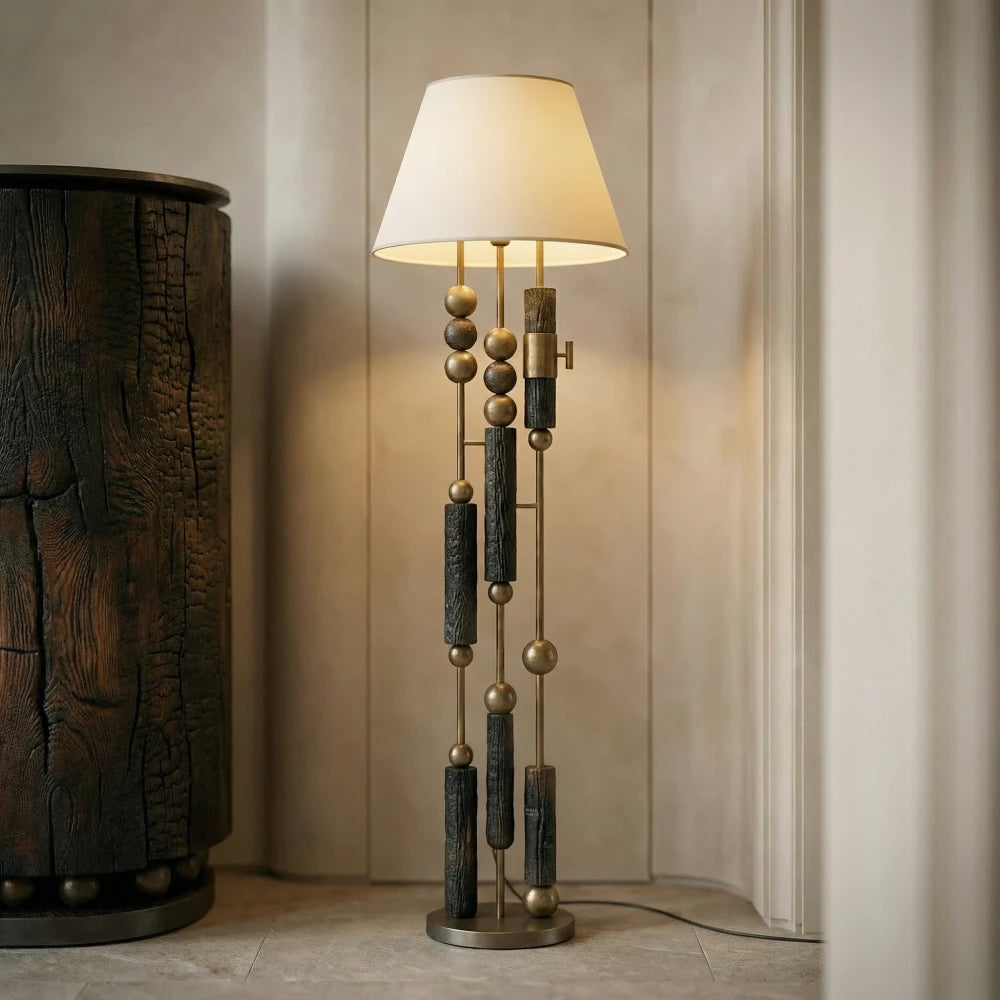Cendre floor lamp by Diamant Versatile, with a cream shade and a tall stem of cylindrical and spherical elements.